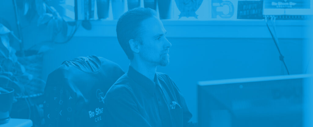 Image of RoShamBo Creative employee working at desk.