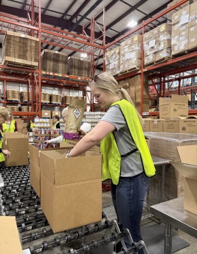 Sam packing food at Feeding South Dakota