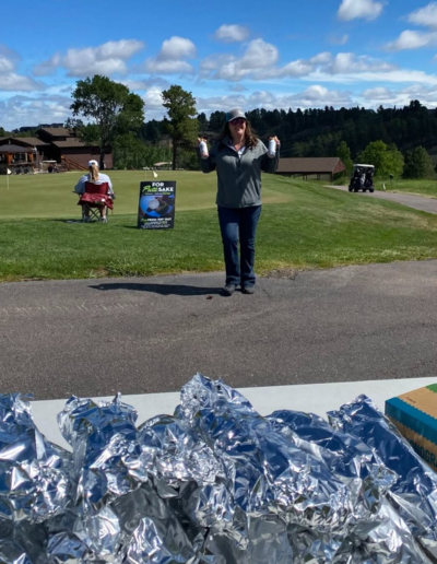 Image of Kandi with hot dogs at Kieffer Sanitation Golf Tournament