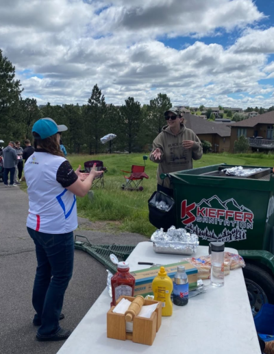 Lauren tossing a hot dog to Kandi at Kieffer Golf Tournament